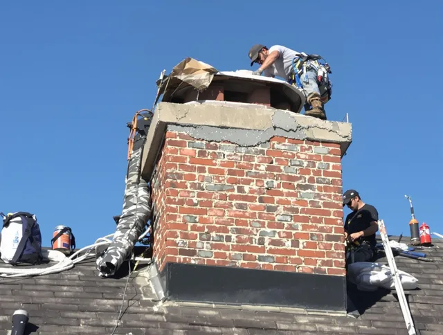 Jurupa Valley Chimney Sweep installing a custom chimney crown in Jurupa Valley, CA